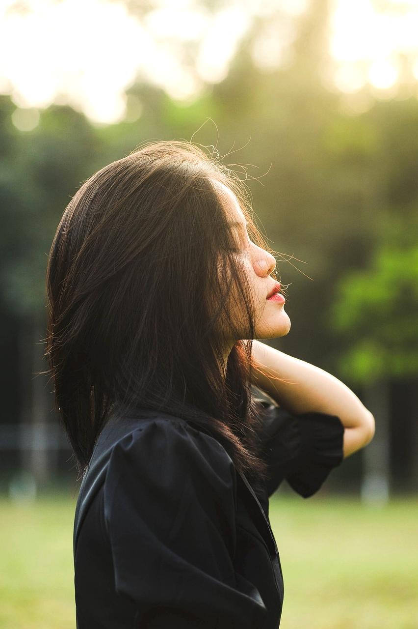 Closeup of hands choosing outfit pieces in wardrobe