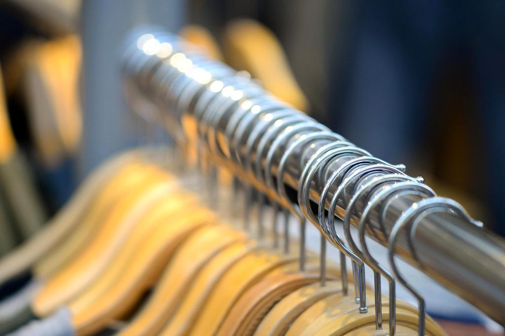 Happy client showcasing their organized wardrobe after consultation