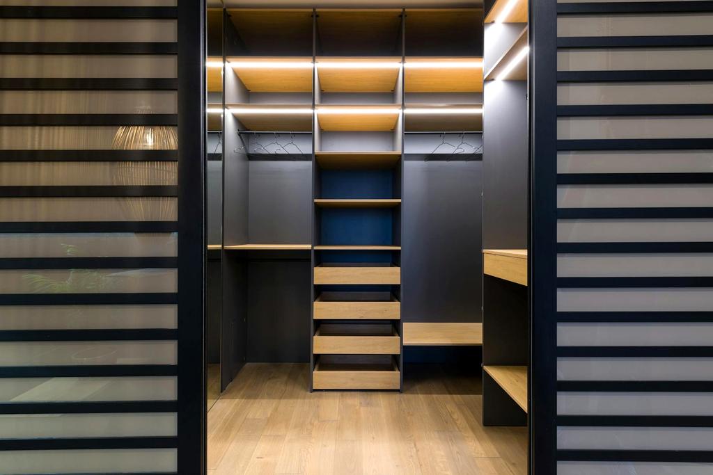 Closet with coordinated outfit sets hanging and shoes neatly arranged